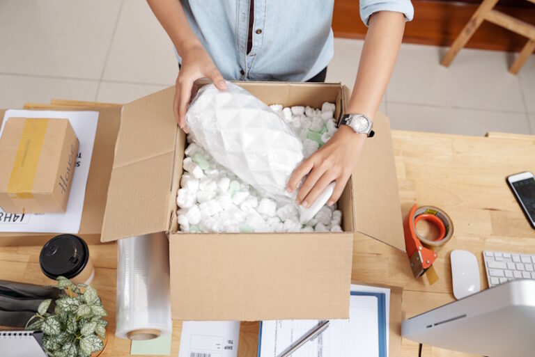 person packing a fragile box