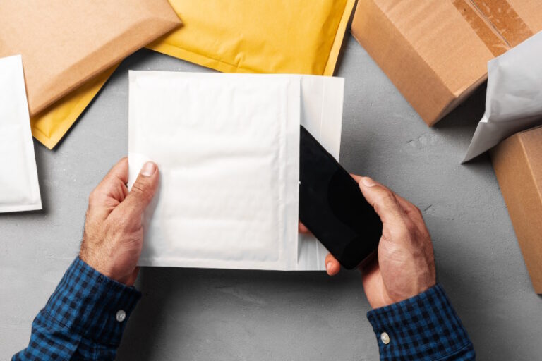man packing bubble envelopes for shipping